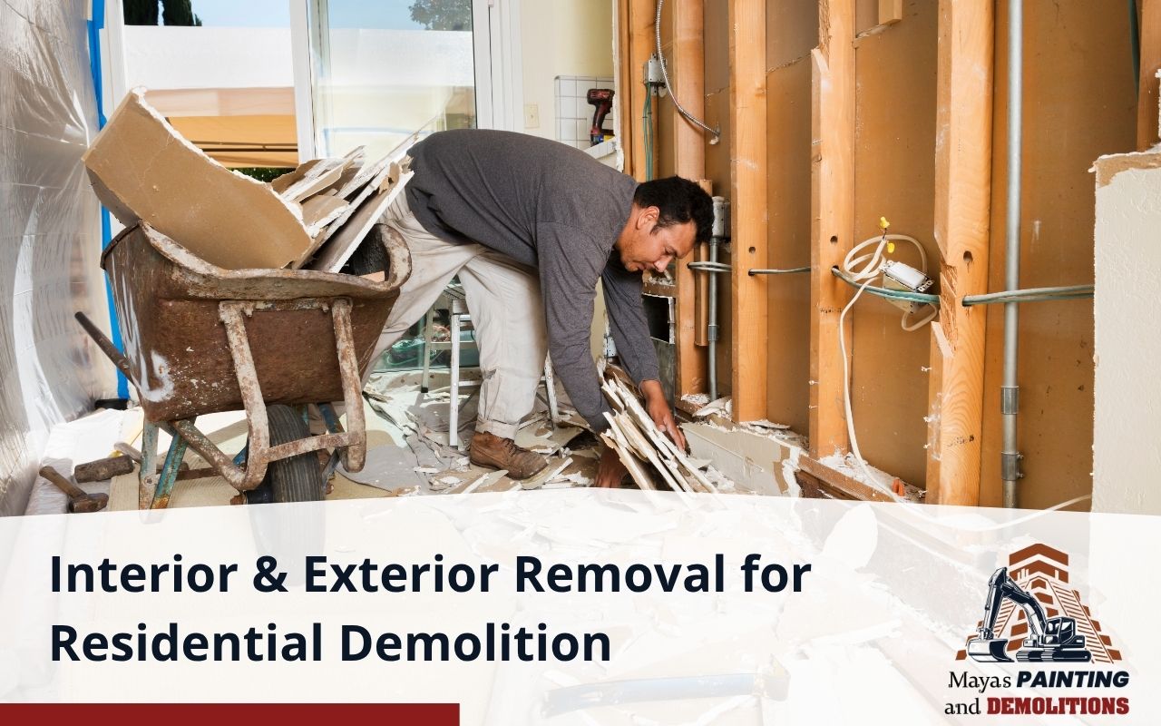 Crew removing interior drywall during home demolition